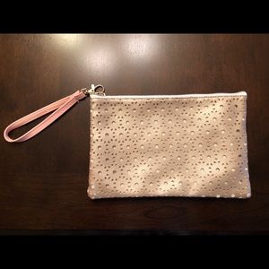 Gold cutout makeup bag with pink wrist strap